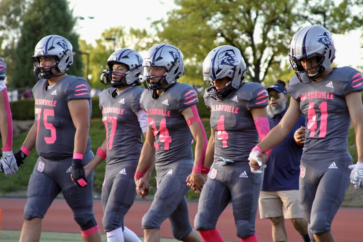 Wilsonville football players lining up on there homecoming game ready to compete and fight together representing there schools and team. Wilsonville in there homecoming beat Forest Grove 51-7.