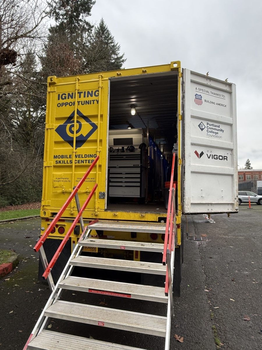 The welding Instructor Joey Bottcher's trail is parked behind the tennis courts. Inside there are 4-5 students working on their welding projects.