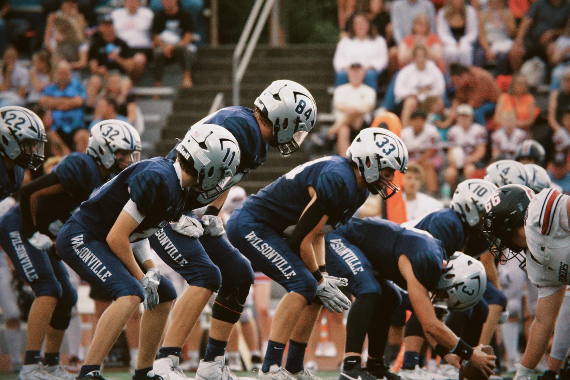 On the field, Wilsonville athletes ready themselves for the play. Wilsonville football has performed exteremely well, especially the past 3 seasons. Coming off of impressive winning streaks, there is definitely a name to live up to. 
