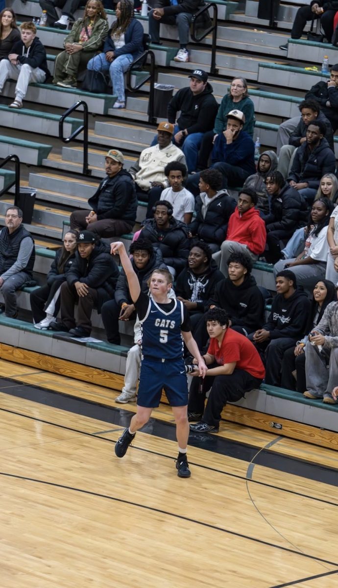 Senior wing Brett Lyons fires a three in the fourth quarter. 