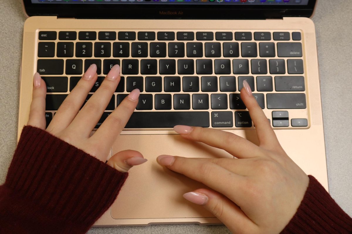 A Senior, Bailee, types on her computer as she navigates to her google classroom. In the past decade, computers have become a vital resource for high school students. 