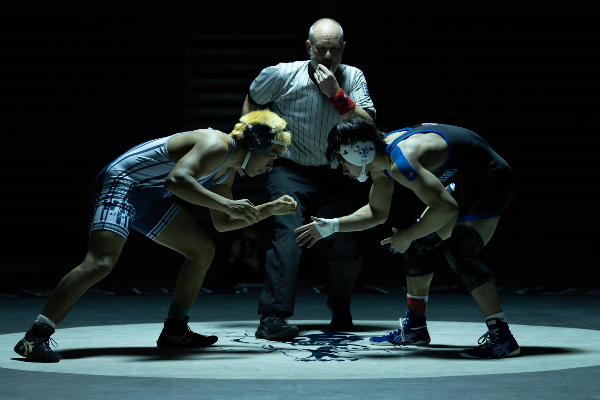 Pabel Garcia faces off at the start of his match. Garcia is a senior on the wrestling team.