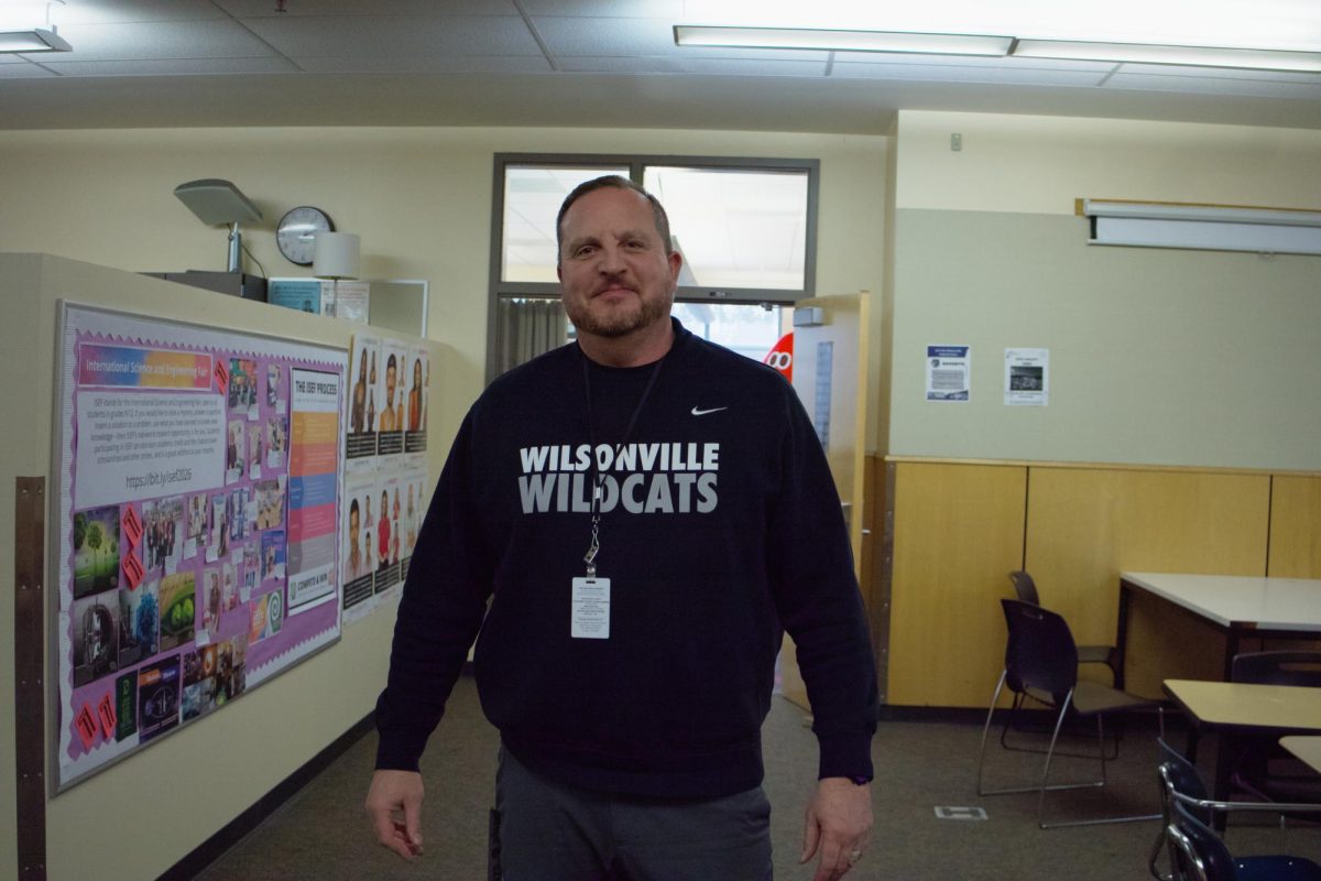 Mr. Davis stands for his photo in between his daily checks around the school. His job is to assist students back to their classrooms and supervise the surroundings of the high school with other staff members. 