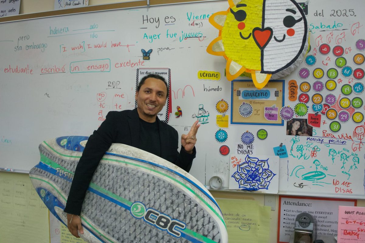 "Profe." Canales is shown holding his bathroom pass for the students in his Spanish class. His surfboard is very popular, and gets a lot of attention but not as much as his teaching style gets. His students appreciate the amount of effort and hard work he puts in to helping each of them everyday.