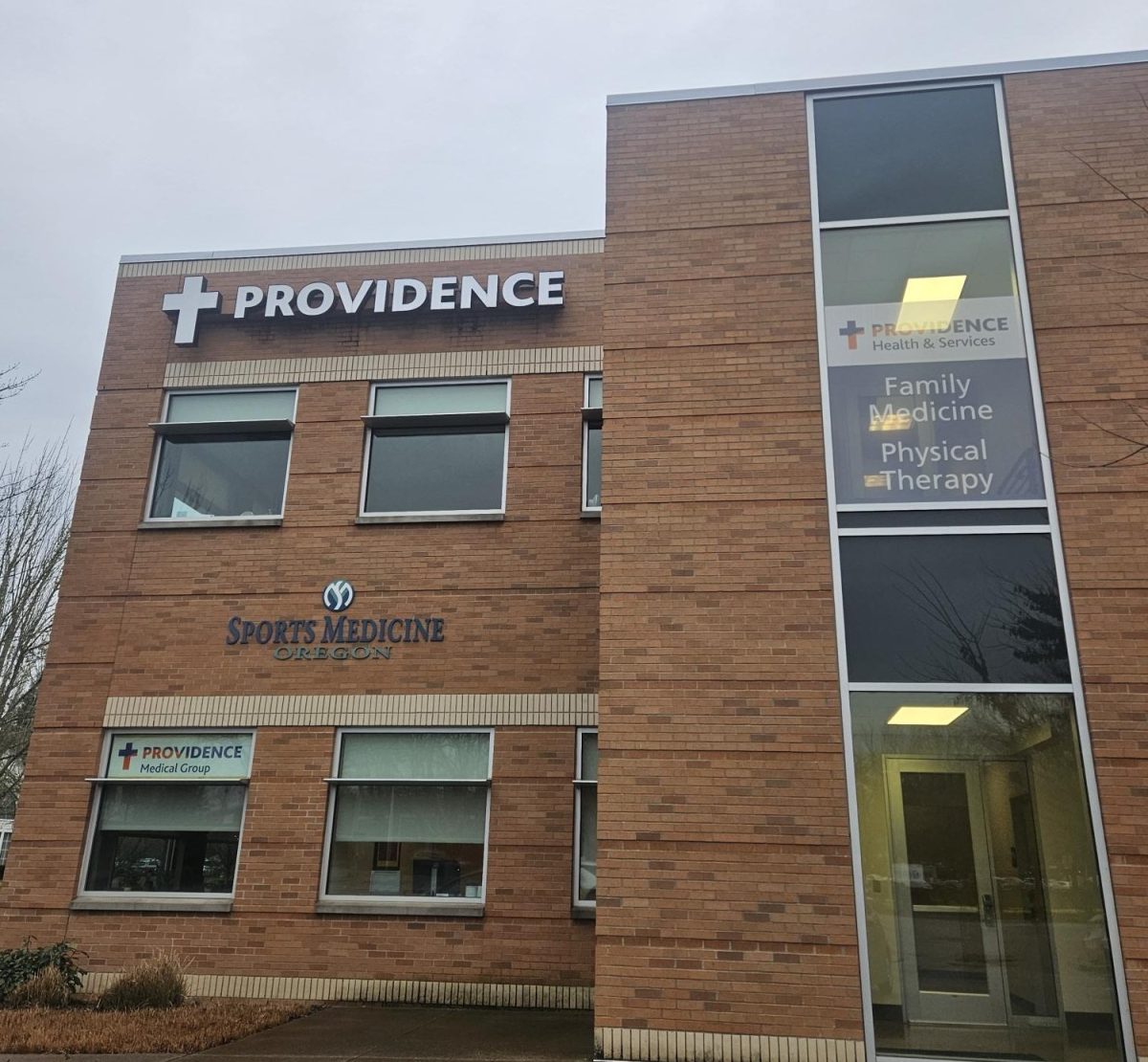A Providence Health &amp; Services clinic in Oregon, featuring family medicine, physical therapy, and sports medicine services. Facilities like this represent the front lines of a healthcare system where access to care increasingly depends on navigating increasingly predatory insurance companies.