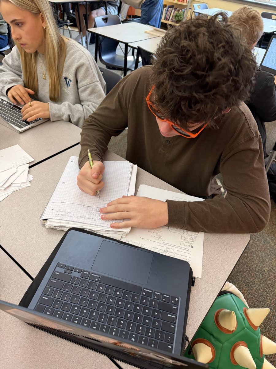 Senior student Spencer Black writes does his Lit homework in style. He is now in one of Mr. Jenkins' smaller classes.