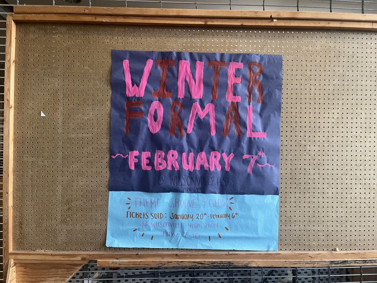 The poster promoting winter formal hangs  on the bulletin board near the back doors of Wilsonville. Ticket prices are $10 with ASB and $12 without. 
