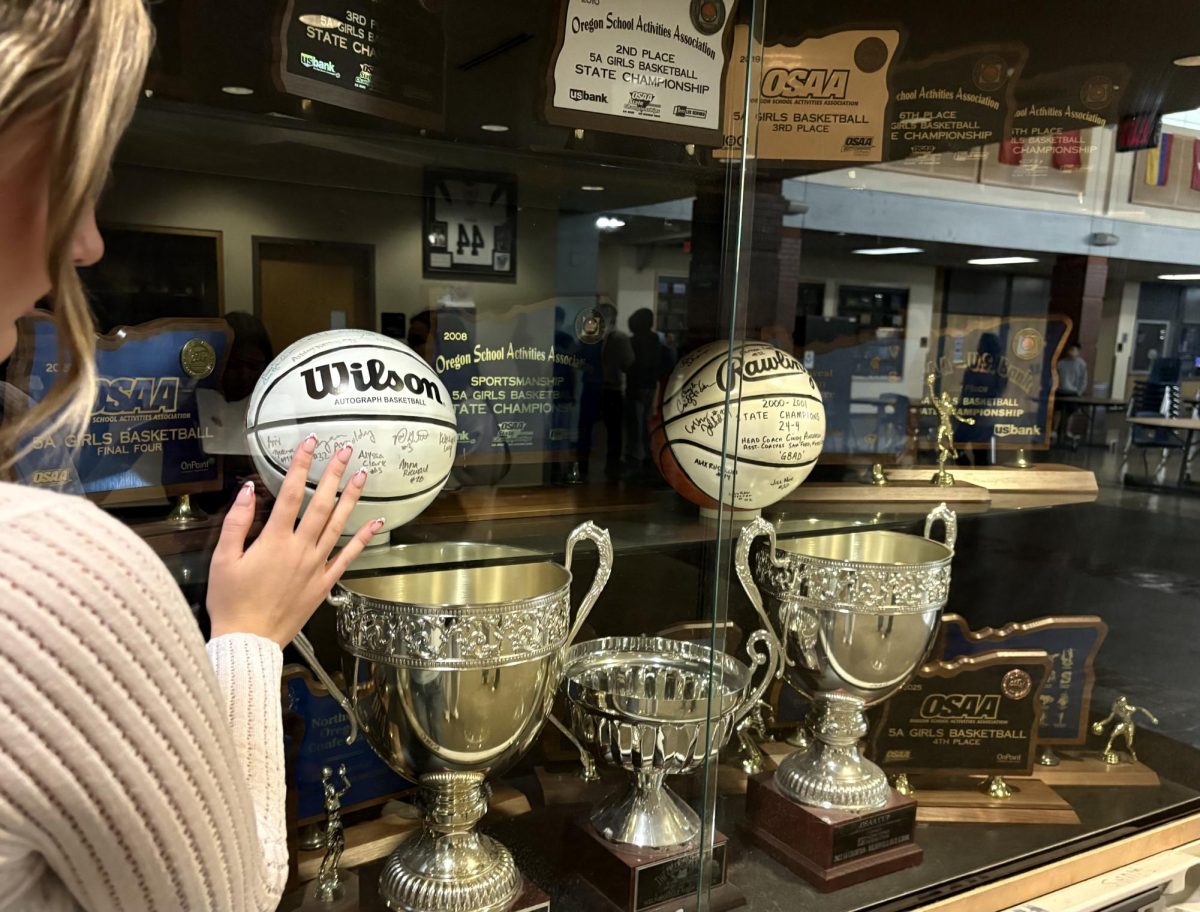 For some, high school is not just a chapter of life, but its defining peak. This student gazes at the trophy case, reflecting on the moments wishing they could relive it.