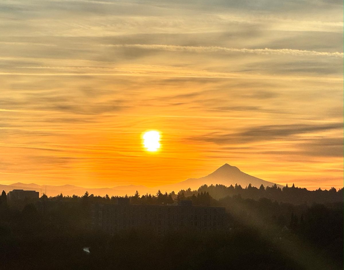 Mount Hood glows beneath a Portland sunset, lighting up the sky in a brilliant orange. Despite scenes like this one, studies show daylight saving time's disruption to sleep schedules outweighs the benefit of extra evening light.