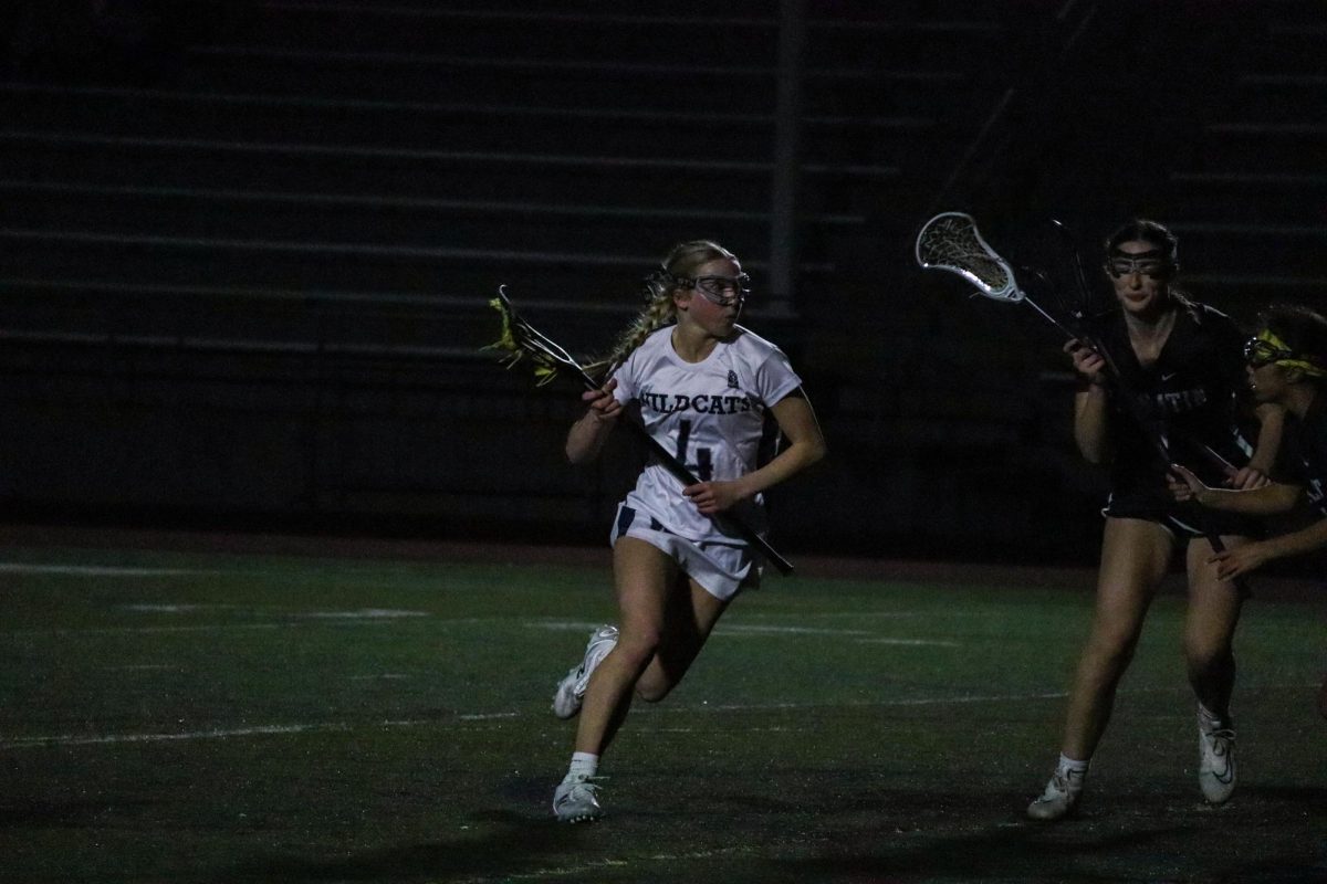 Senior Finley Blankenship runs pasts defenders looking to score a goal. Wilsonville this season demonstrates and strong midfield and atack very lethal in front of goal.