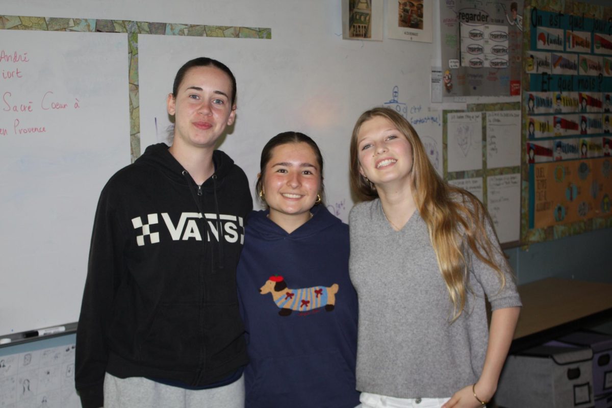 Capucine, Morgan, and Louise all pose for a photo. Both Morgan and Capucine are parts of the year-long program, while Louise is here for a month. 
