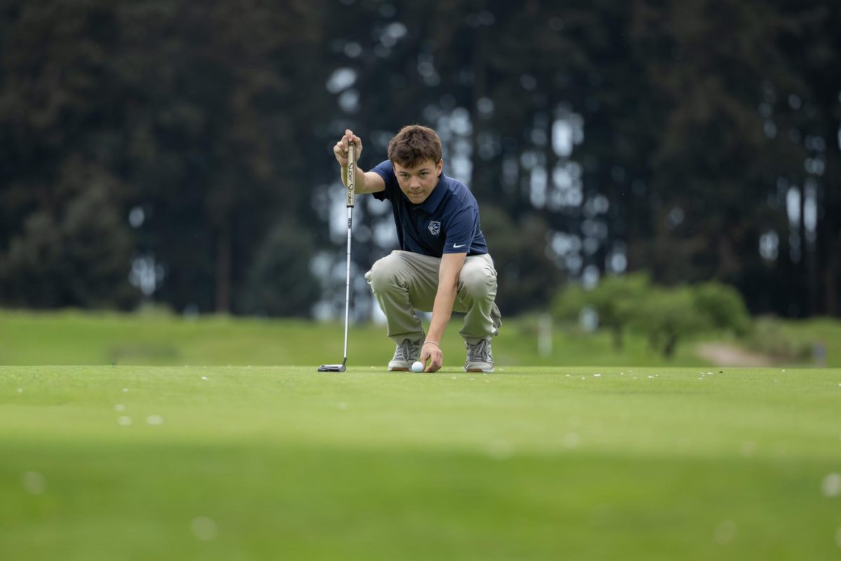 Senior Simon Bonfiglio measures a shot at a boys golf match held at Langdon Farms on April 20th. Wilsonville hosted the event and took 3rd place.