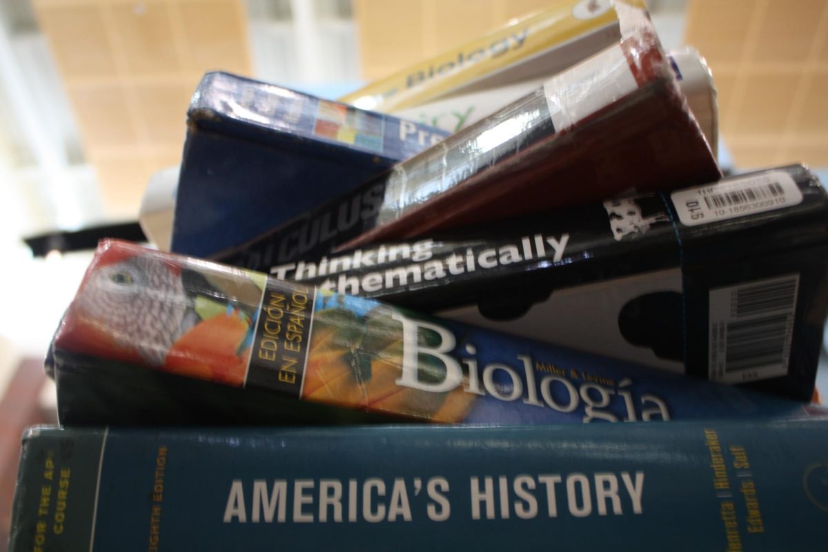 This is a low angle shot of a complex stack of textbooks. It represents the weight and challenge of academic study that could sway which year is viewed as the most difficult.