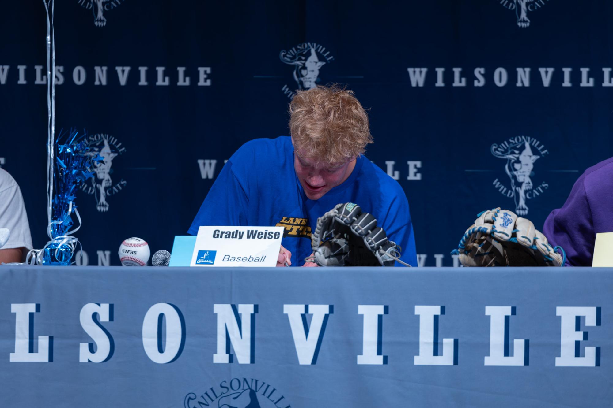 Grady Weise signs his letter of intent. He will attend Lane Community College next school year.
