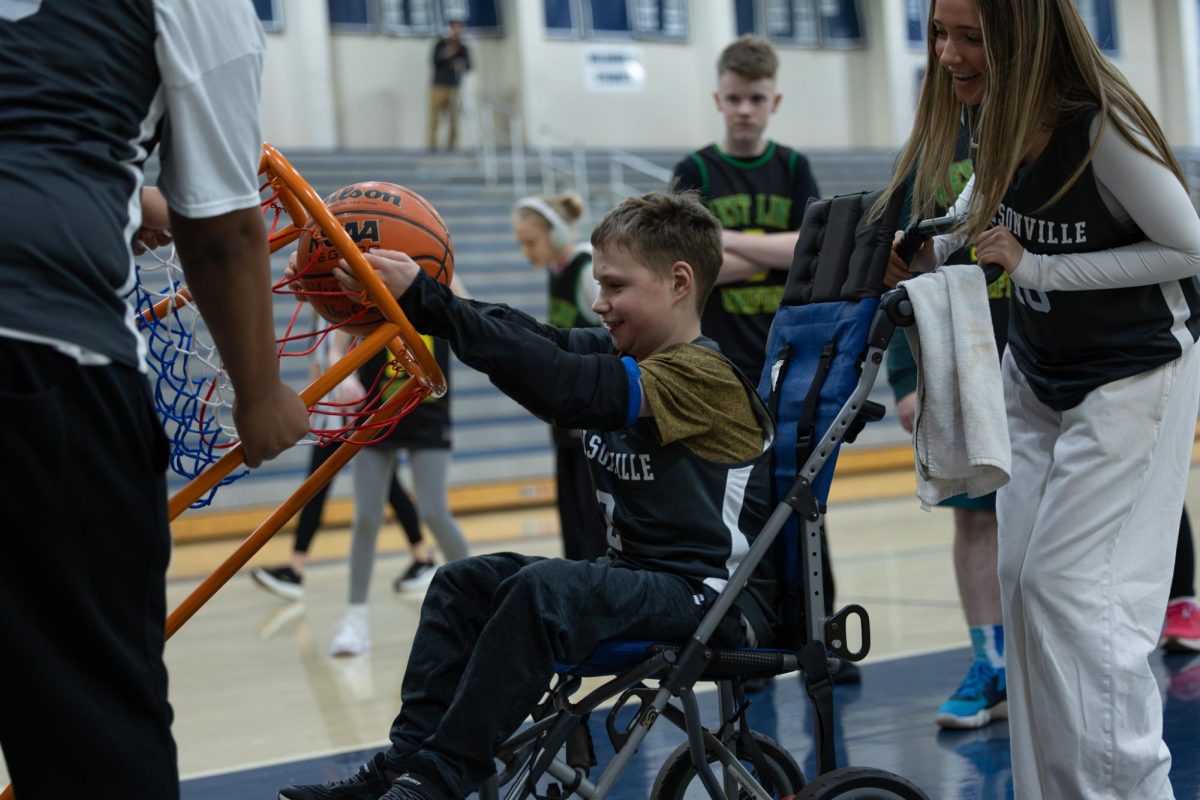 Noah Wilson dunks (with the help of Marlee Metzler).  Both players had a great game.