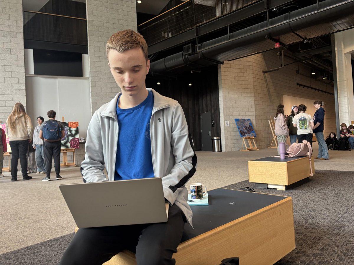 Sophmore Luke Heberlein works on homework during an afterschool rehearsal. Both actors and techs have to cram in study sessions whenever they can.