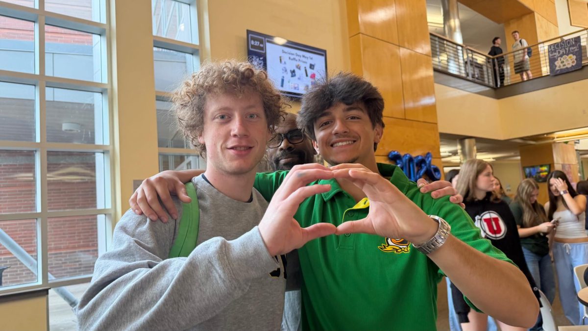 Seniors Michael Hanson and Ayoub Laouamri pose for a picture during decision day. Both seniors plan to attend University of Oregon and study business in the fall.