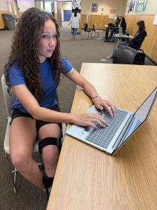 Junior Justine Sheets sits in front of her Spanish classroom. She prepares for her Spanish III final by studying previous material on her computer.